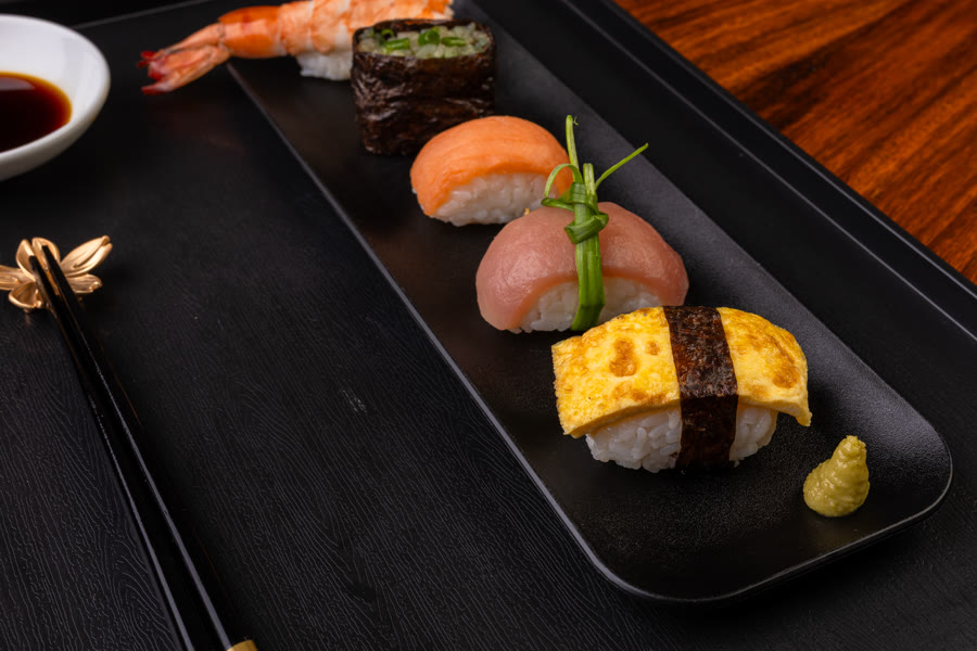 Assorted nigiri platter on a black tray