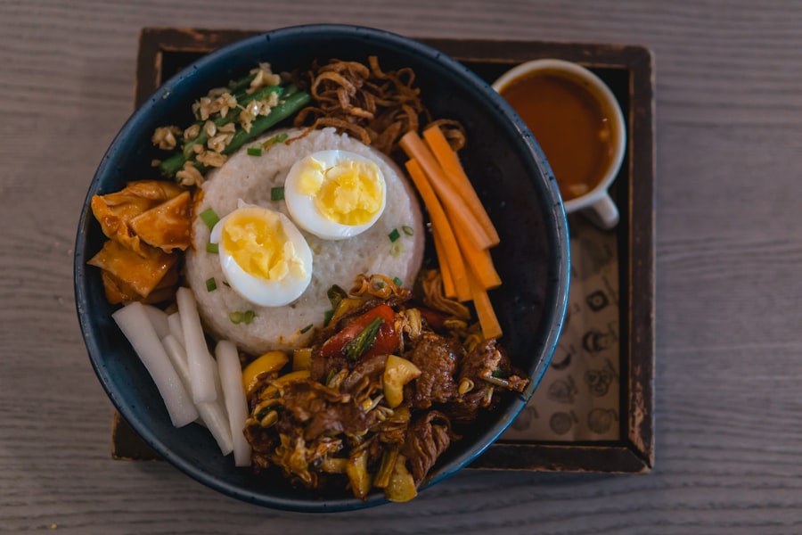 A rice bowl with soft eggs on a dark tray